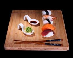 Five species of fish sushi on bamboo board photo