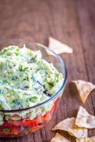 Bowl of guacamole with salsa photo