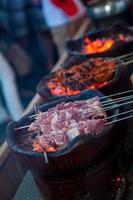 Indonesian food Satay raw klatak meat being grill photo