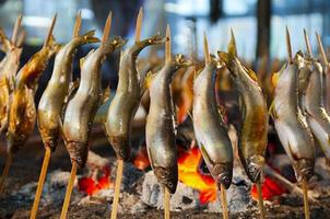 Japanese street food, grille freshwater fish skewers. photo