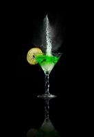 Glass of martini with lime and splashes
