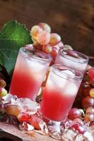 Cool pink grape juice with ice photo