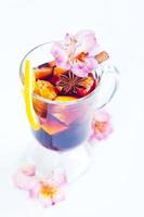 flowers and mulled wine in glass photo