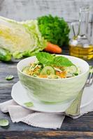 Cabbage salad with cucumber and carrots photo