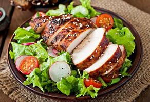 Fresh vegetable salad with grilled chicken breast photo