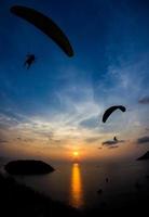 Paragliders at sunset