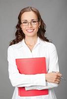 Businesswoman with folder, on gray photo