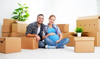 moving to  new apartment. family pregnant wife and husband with photo