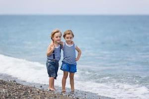 Two kids on the beach photo