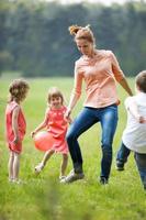 Happy familiy playing football, outdoors photo