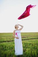 Portrat of  young pregnant woman in a white greek dress photo
