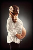 Pregnant woman holding her belly photo