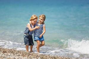 Two kids on the beach photo