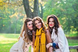 Three beautiful young women in the park photo