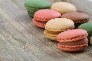 Selection of colorful macaroons on wooden background photo