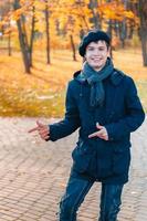 Happy teenage boy in the autumn sunny park
