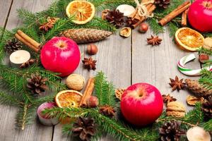 Christmas decoration with fir tree, oranges, cones, spices, appl photo