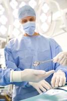 Surgeons performing operation in hospital operating room