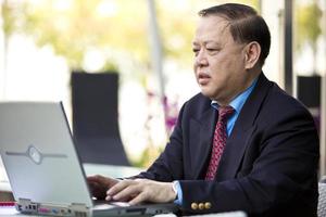 Asian businessman using laptop PC
