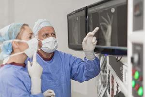Surgeon examining x-rays in hospital photo