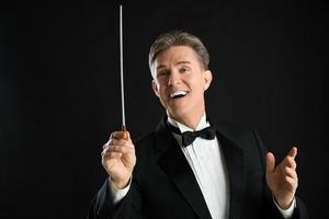 Male Orchestra Conductor Looking Away While Directing photo