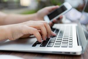 Closeup of business woman hand typing on laptop keyboard photo