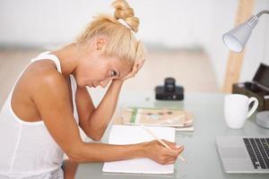 Worried woman doing some work in her desk