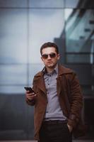 handsome businessman with smartphone photo