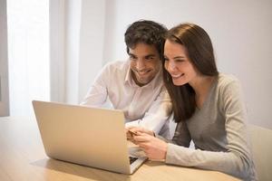 Couple using credit card to shop on line. Laptop. Indoor