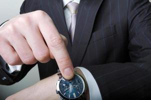 Businessman pointing at his watch