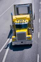 Big rig yellow power semi truck reefer trailer interstate highway