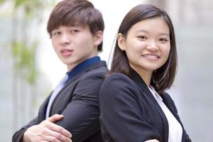 Young female and male Asian business executive smiling portrait photo