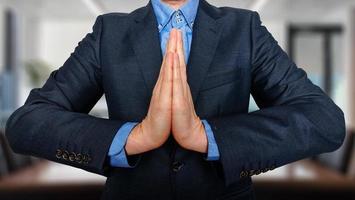 Business and office, people concept - praying young buisnessman