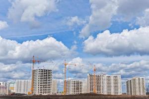 Construction site with cranes on sky background photo