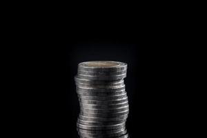 Pile of coins on black background