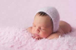 Newborn Baby Girl Wearing a Pink Knitted Bonnet photo