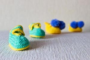 Newborn wool knitted shoes. Selective focus photo