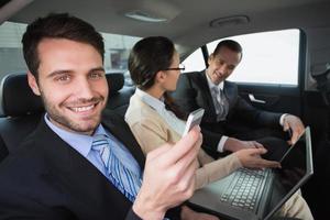 Business team working in the back seat