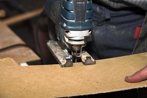 Worker cutting wooden board