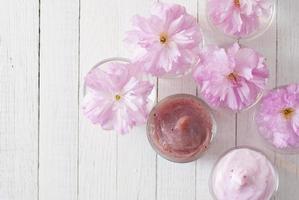 Cosmetic creams with cherry flowers photo