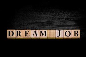 Message DREAM JOB isolated on black background photo