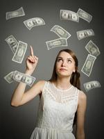 Young girl in white and dollars. photo