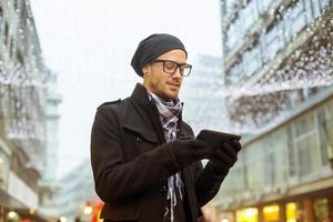Hombre urbano holdin tablet PC en la calle