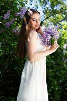 Beautiful girl with a lilac flowers photo