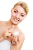 Skin care. Girl applying moisturizing cream