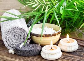 Spa Setting wiht Green Leaves and Burning Candles photo