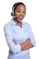Funny african phone operator with headset and crossed arms photo