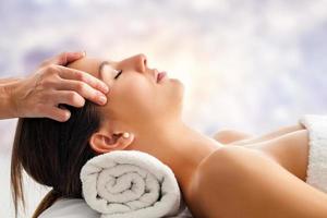 Woman having relaxing facial massage. photo