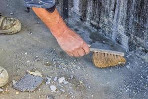Construction Worker with broom sweeping concrete 3