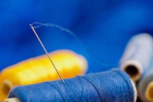 needle and blue and yellow thread, shallow depth of field